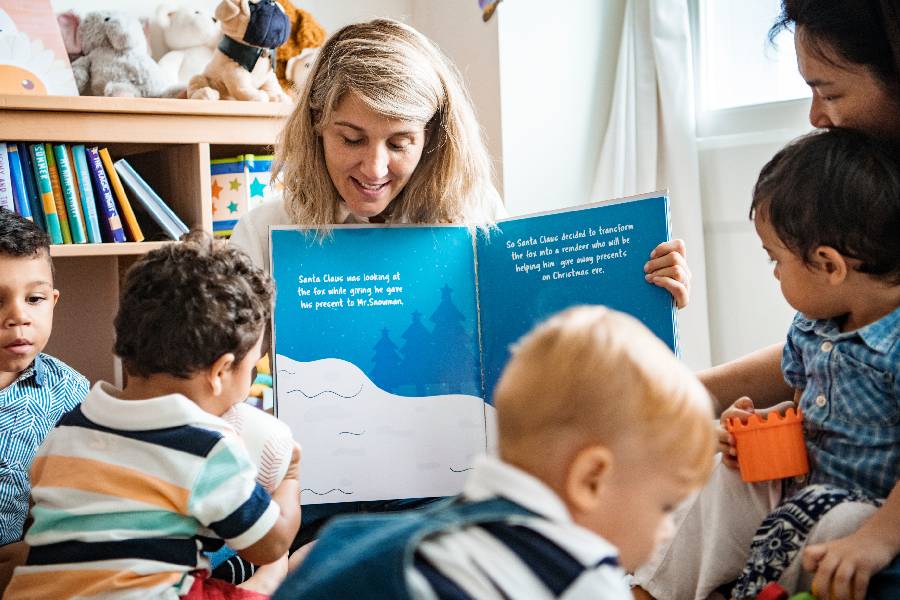 Teacher and students reading a Christmas story together